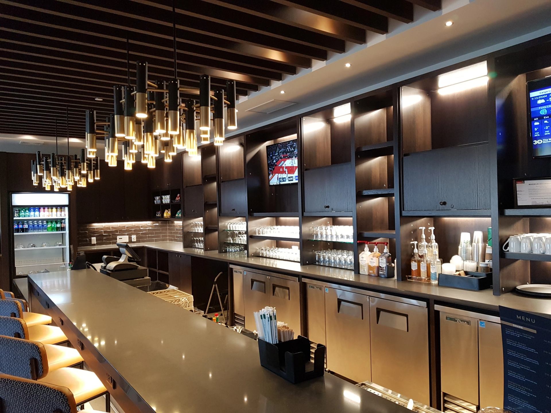 Hyatt Place bar with sleek counters, modern lighting, and beverage display.