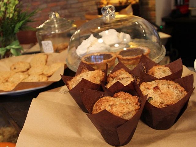 Baked goods on a cafe counter—muffins and cookies.