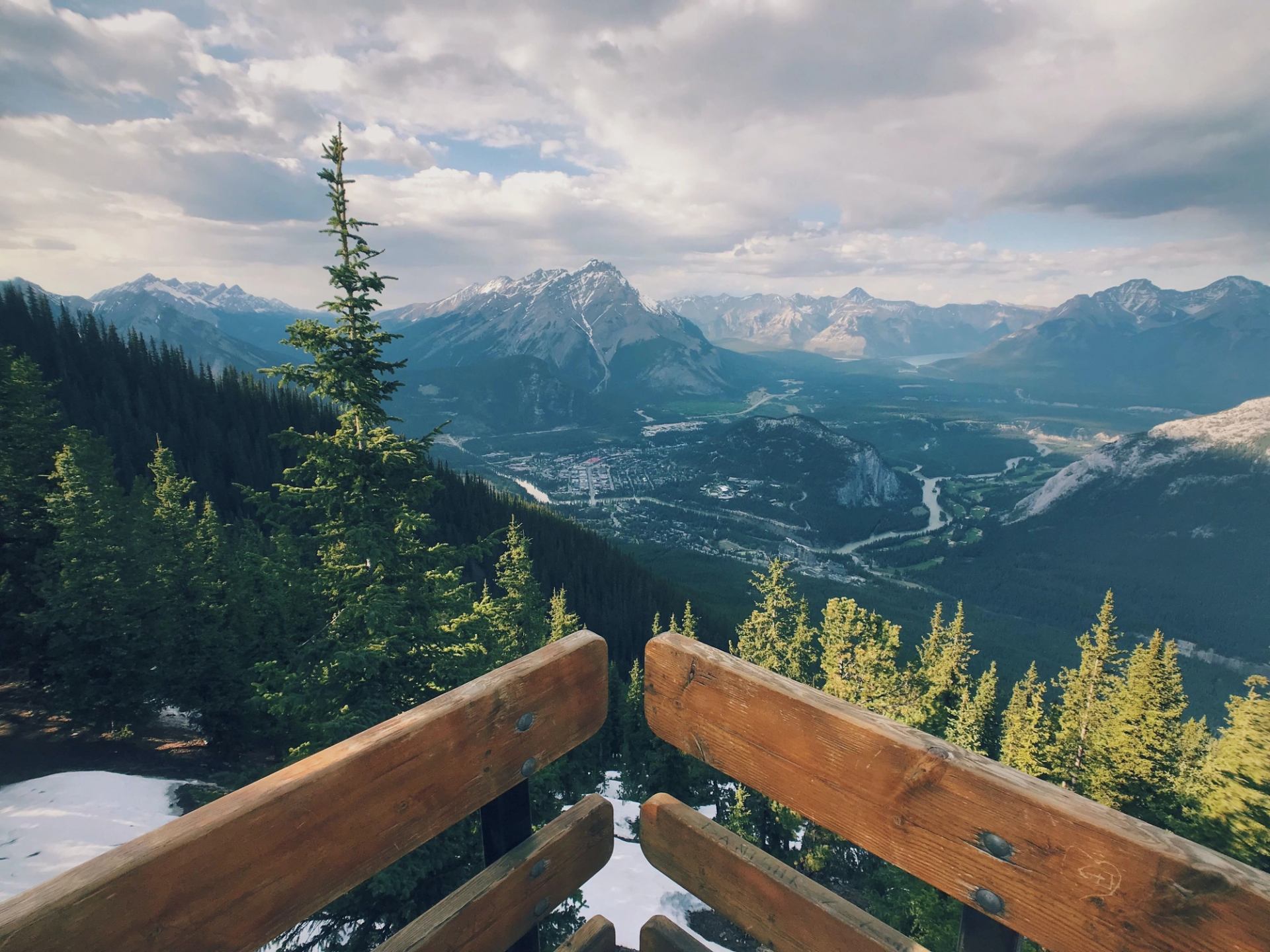 Scenic mountain view from a wooden observation deck.
