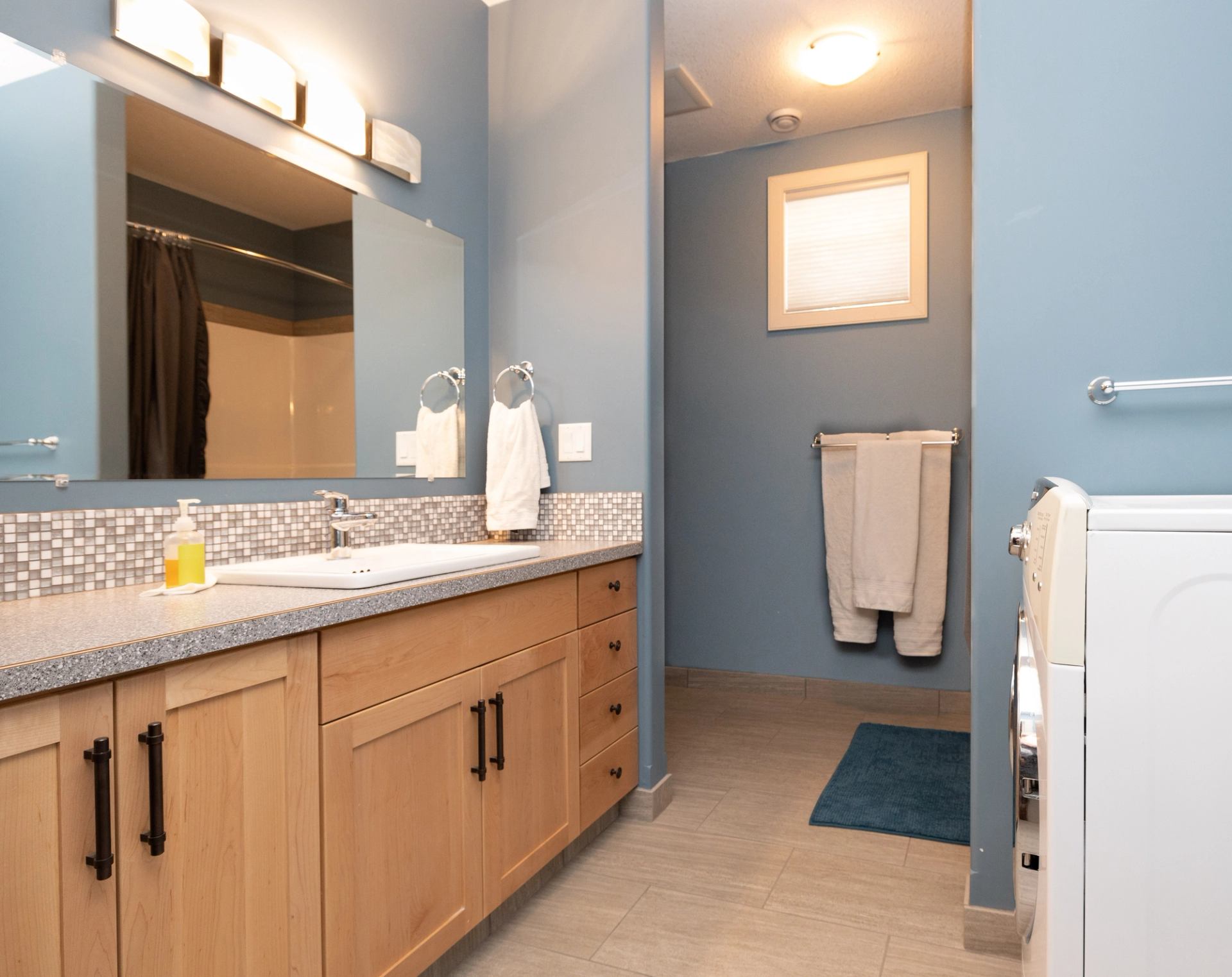 Modern bathroom with double sinks and granite vanity.