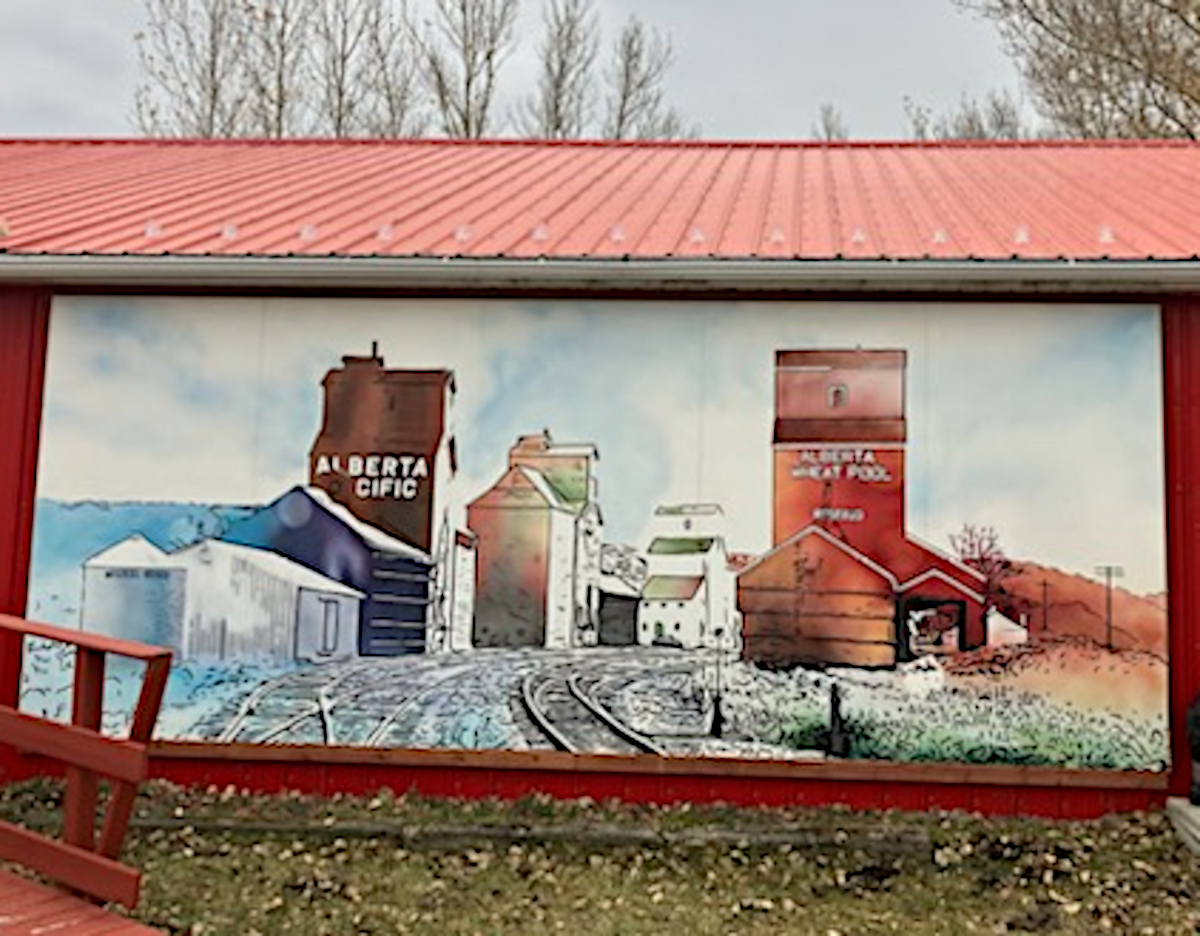Artistic recreation railway tracks with 3 grain elevators of left and Alberta Wheat Pool on right