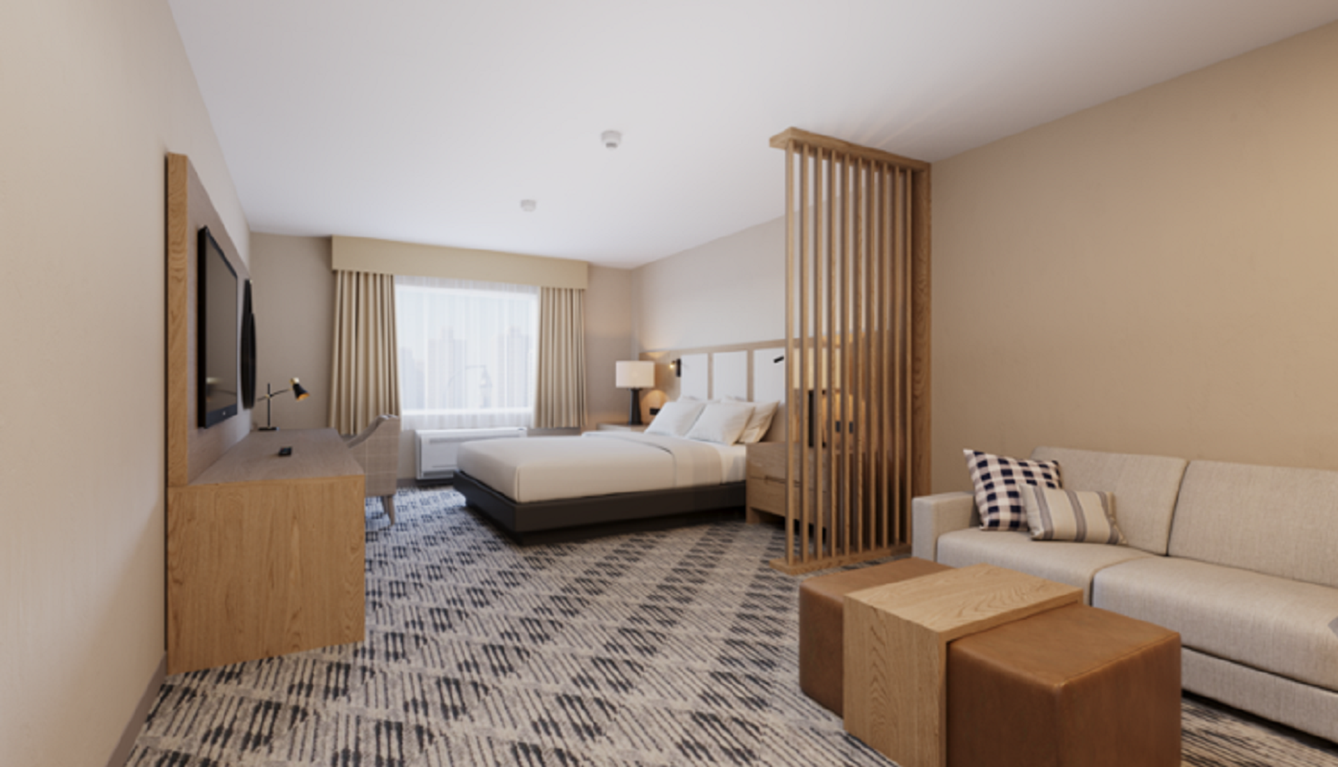 Hotel room with bed, sofa, wooden divider, desk, television and window.