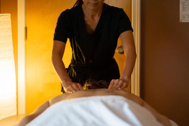 Massage therapist working on back at Jasper Wellness.