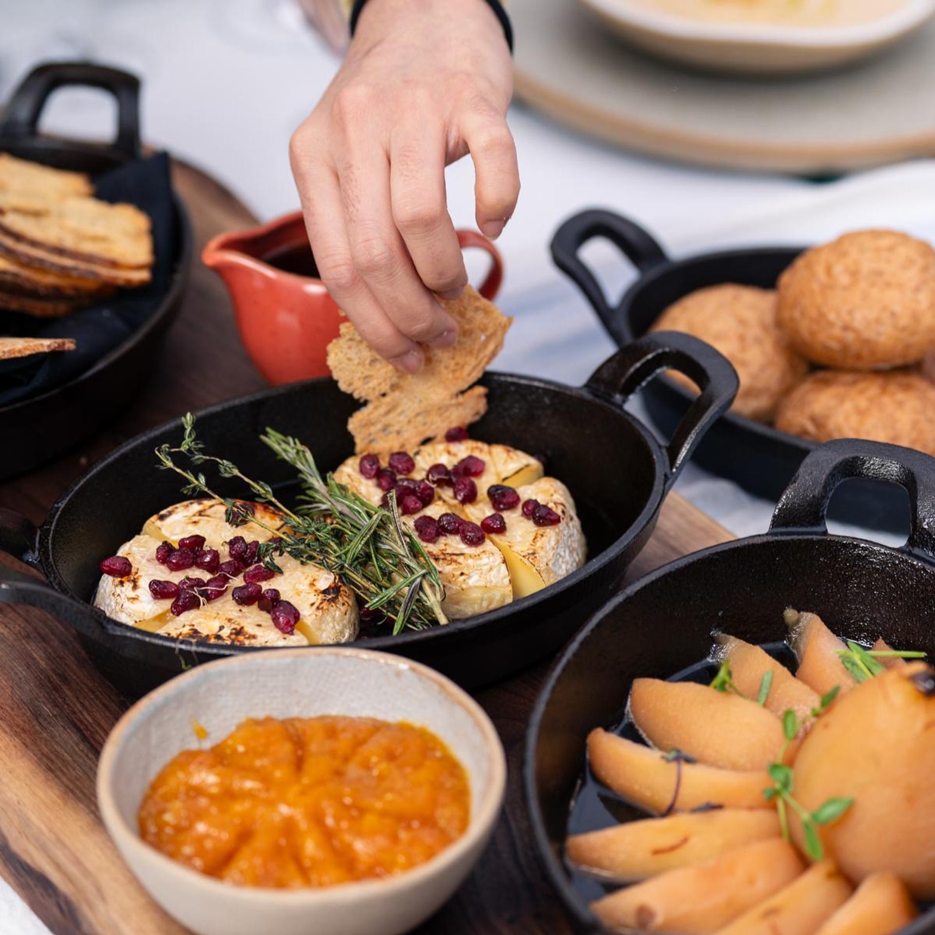 Guests sit together enjoying a variety of brunch dishes inside a garden dome.