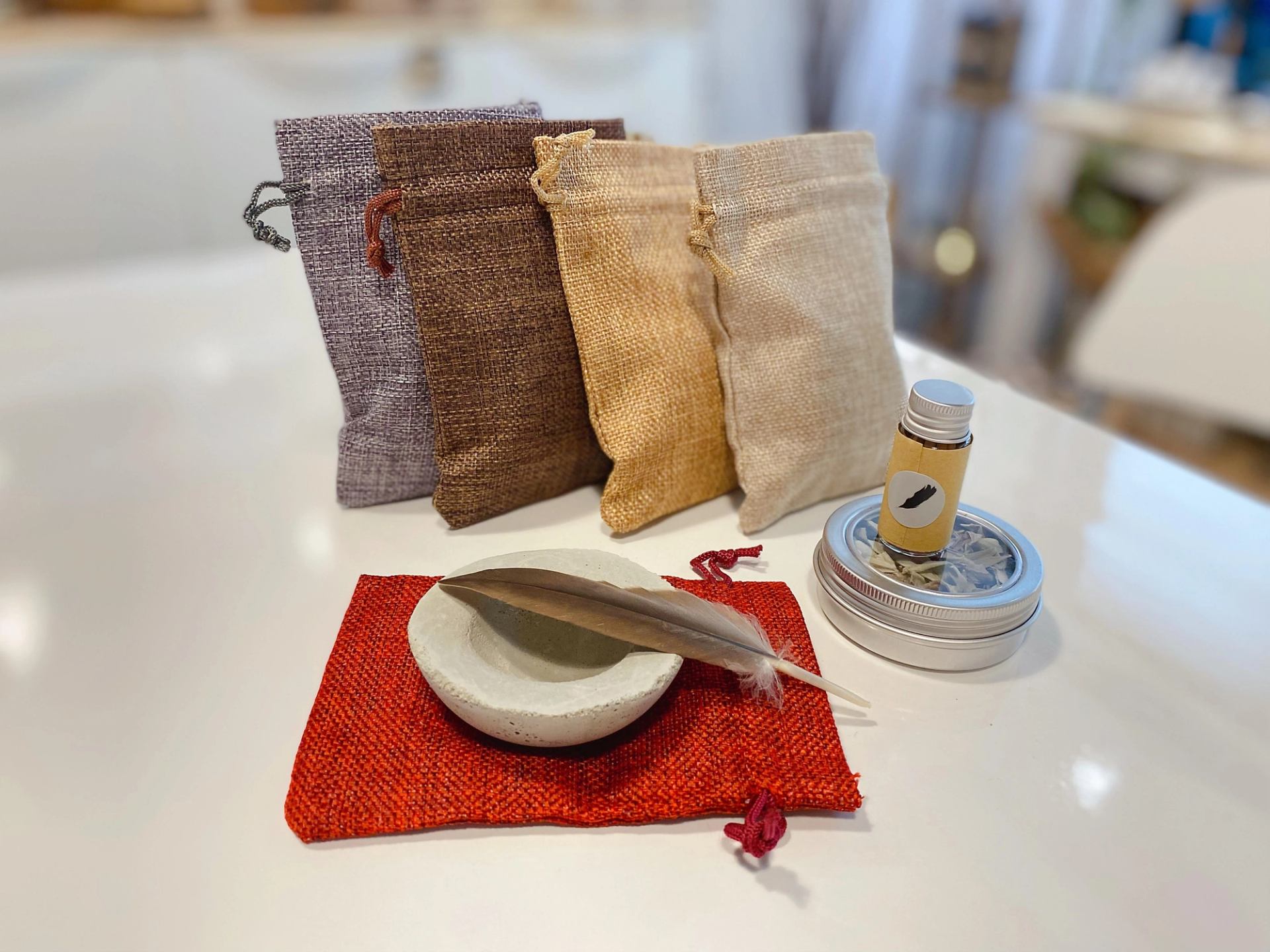 Craft gift bags with a candle and incense holder on a tabletop display.