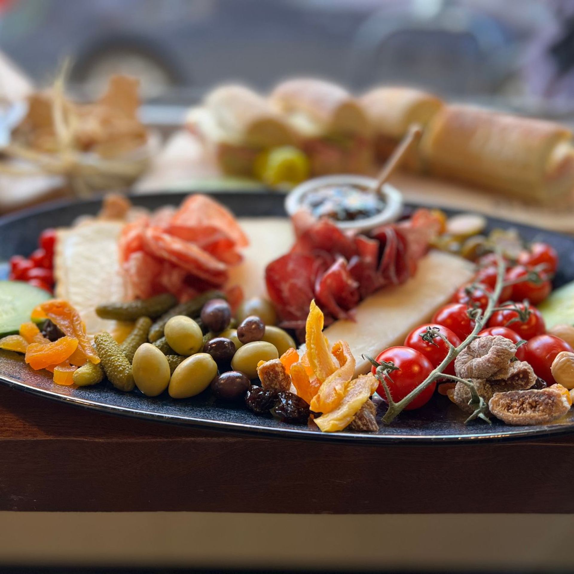 Charcuterie board with meats, cheeses, fruits, and bread from Canmore Food Walk Tours.