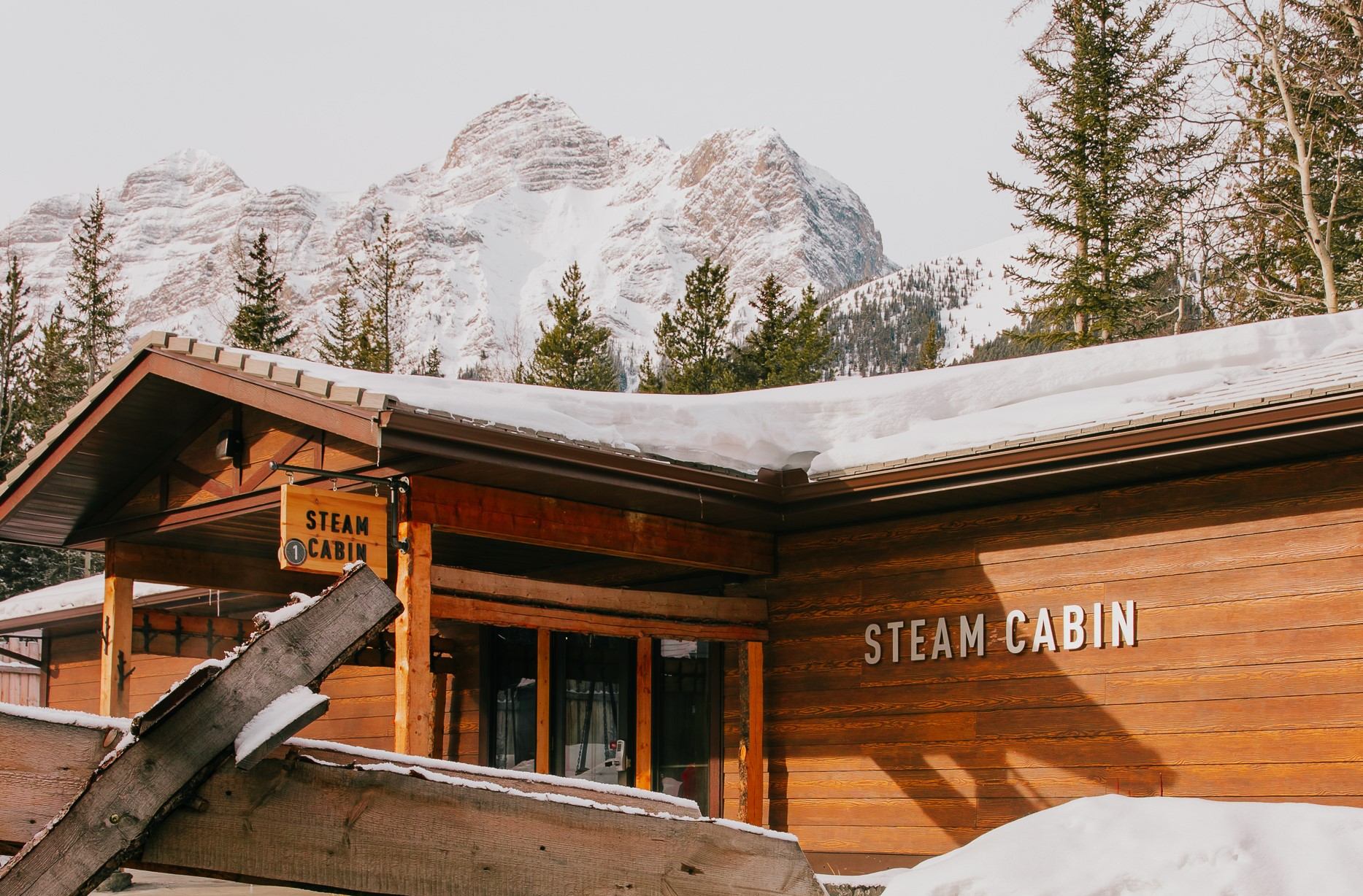 A chute spills water into a pool at the Kananaskis Nordic Spa.