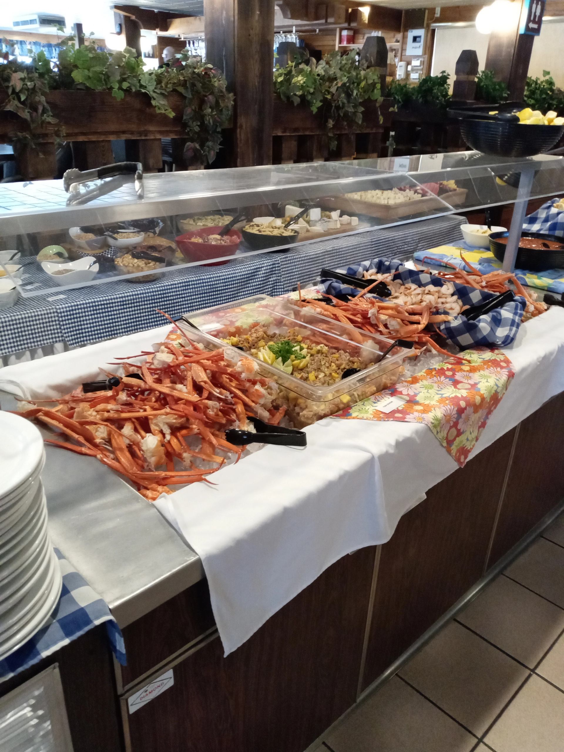 Seafood buffet with crab legs, shrimp, and assorted dishes at The Crossing Resort.