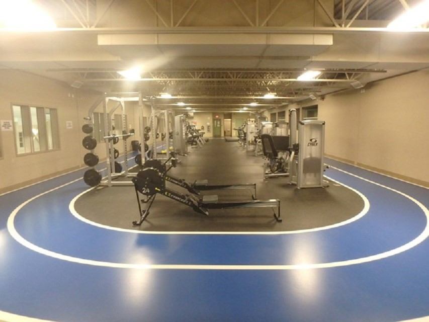 Gym room at Beaverlodge Recreation Centre with exercise machines and free weights.