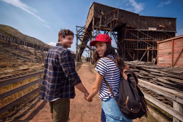 Couple holding hands and walking outside at Atlas Coal Mine.