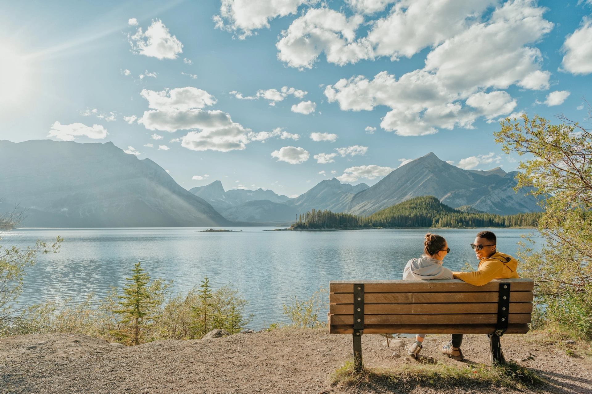 Couple sitting on a bench looking out to Upper Kananaskis Trail.