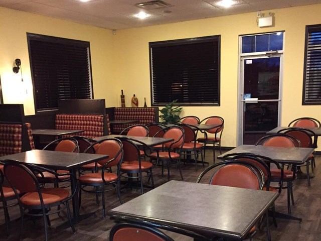 Cozy dining area with booths, tables, and warm lighting at Piccolos Pizza & Pasta.