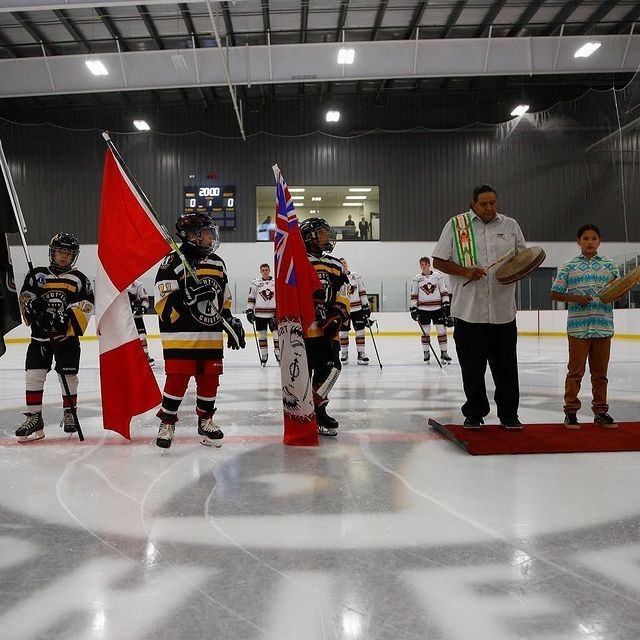 The Calgary Hitmen lined up on the ice