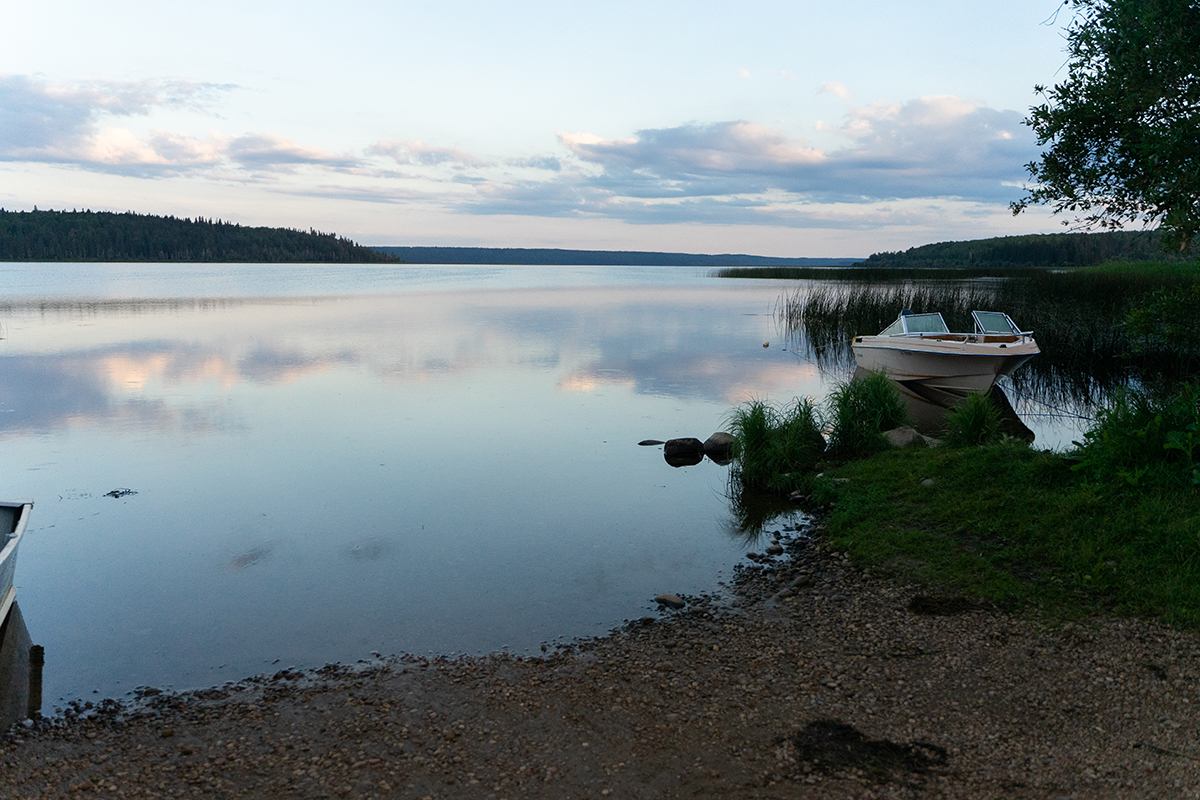 A motorboat pulled up on shore early in the morning.