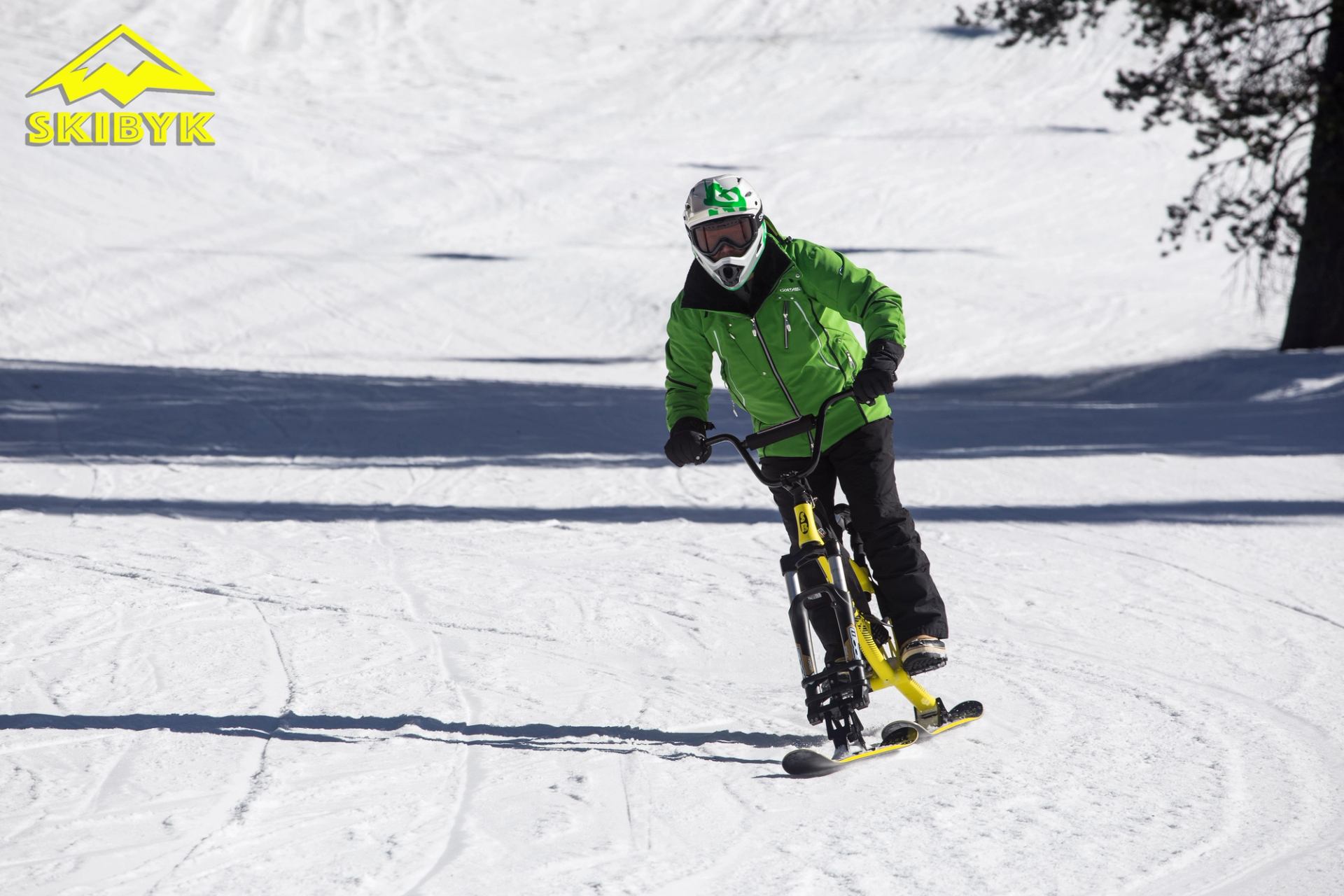 a person going down a hill on a ski bike