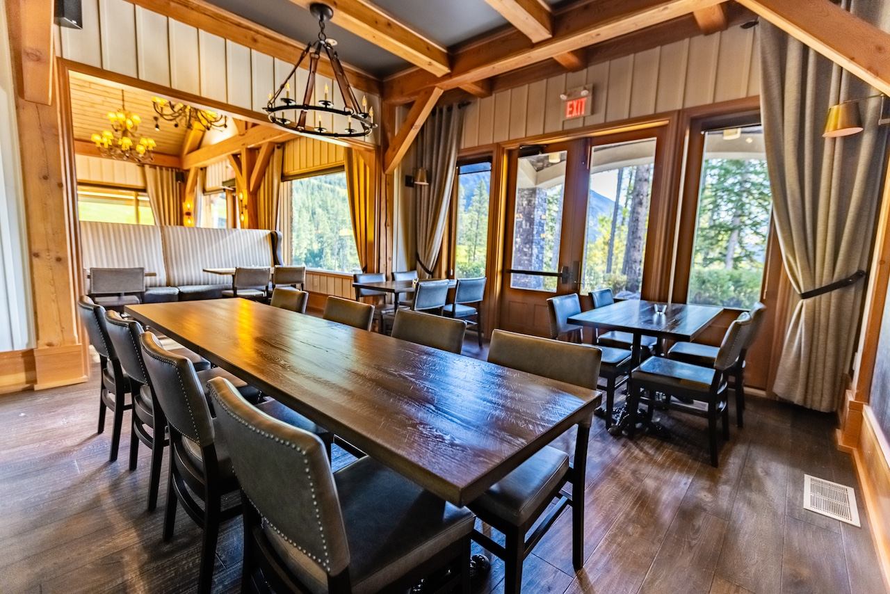 Meeting room with wooden beams, large windows, and a long conference table