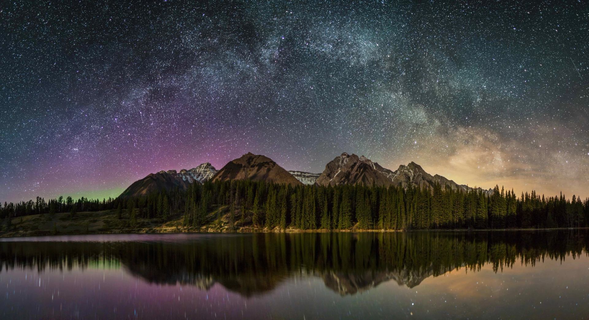 Starry night sky over mountain at Johnson Lake.