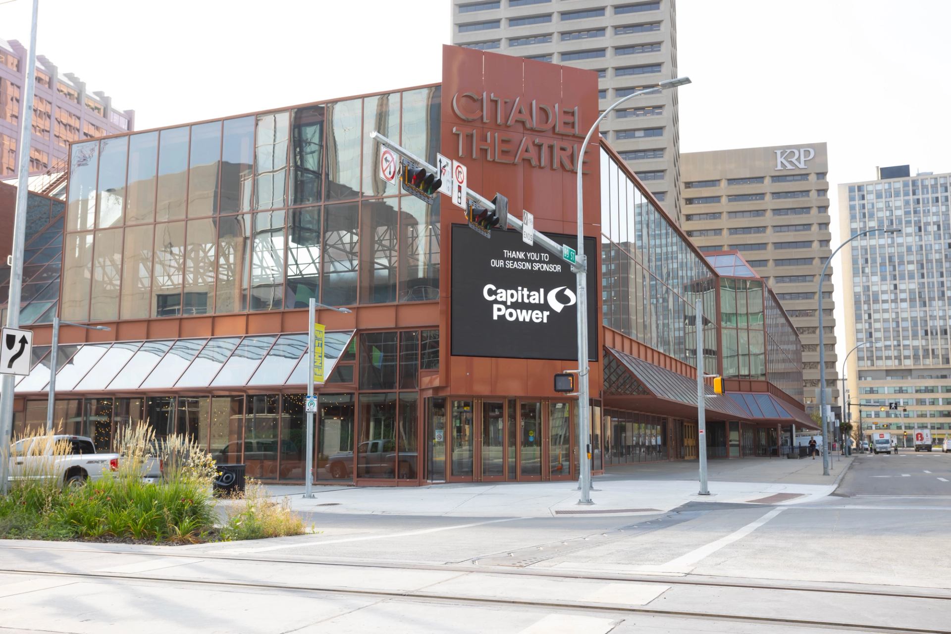 Citadel Theatre's glass exterior stands at a downtown intersection with surrounding office towers.