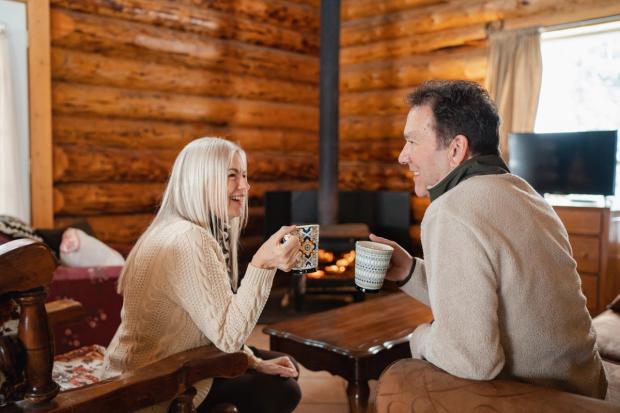 Couple enjoying coffee in a cabin at Anchor D Guiding & Outfitting.