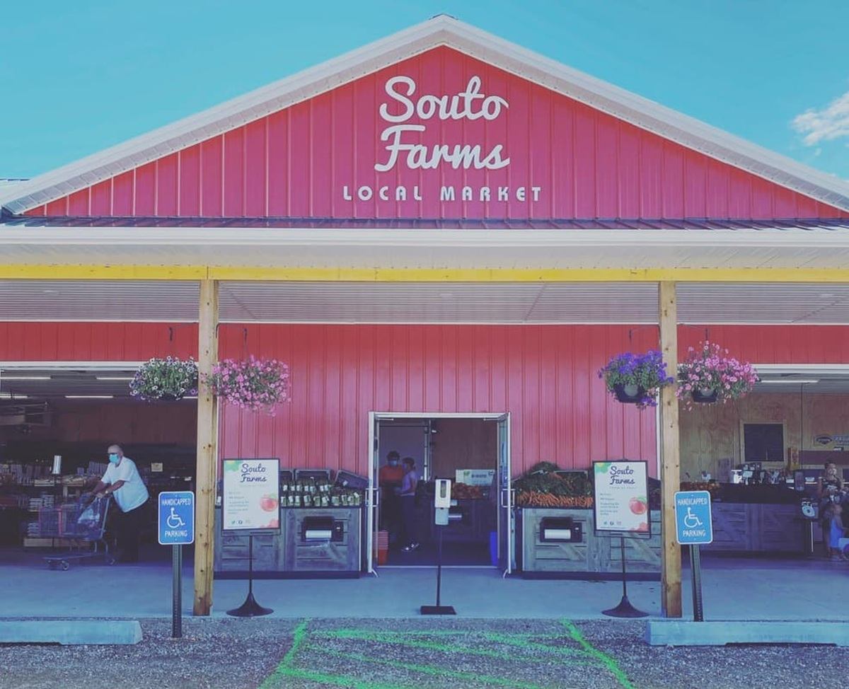 Red Souto Farms local market exterior with hanging flowers and accessible parking signs.
