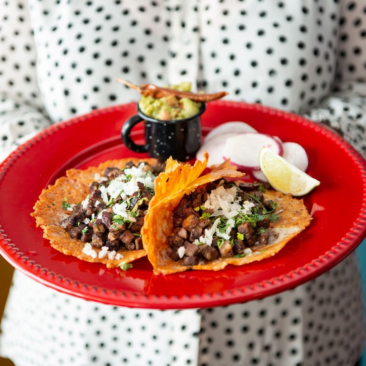 A person carrying a plate of food.