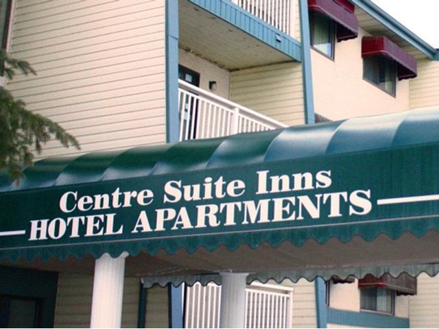 Green entrance awning reading “Centre Suite Inns Hotel Apartments” on the exterior of the building.