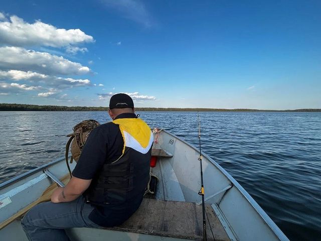 A man on a fishing boat on Wabamun Lake.