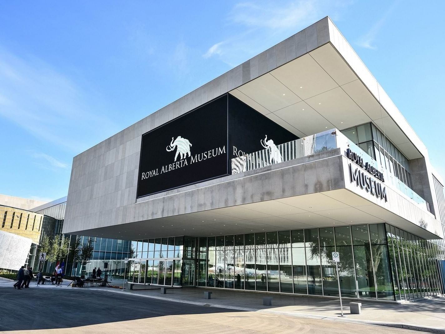 Royal Alberta Museum exterior with mammoth logo and glass entrance under clear sky.