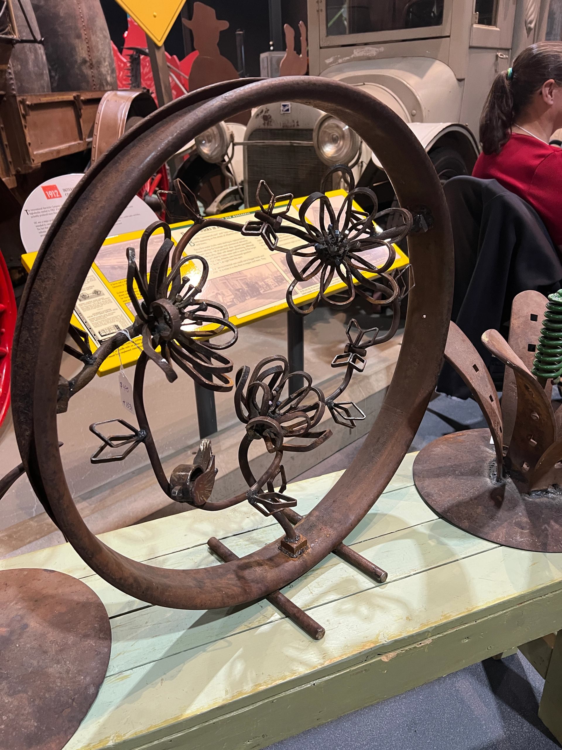 Circular metal artwork featuring detailed floral designs on display.