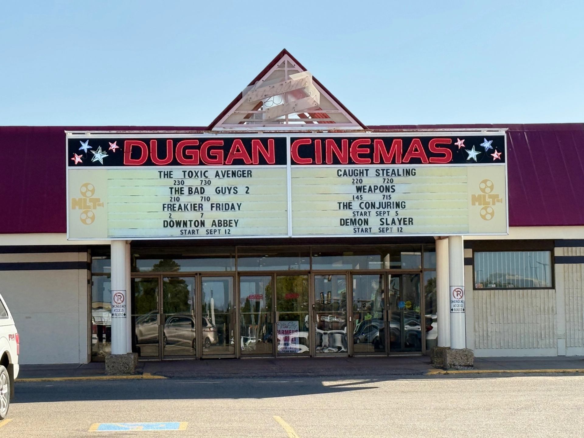 Exterior of Duggan Cinemas with marquee listing current movie showings.