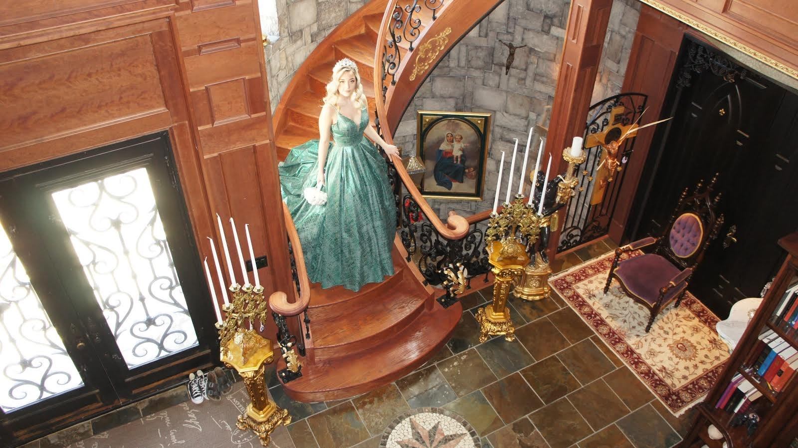 A women coming down the stairs inside of Ryans Castle BnB.