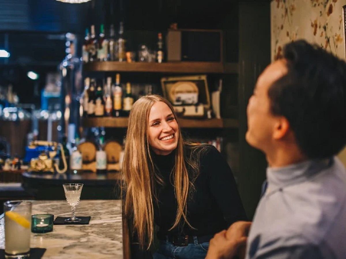 Two people sharing a good time and cocktail