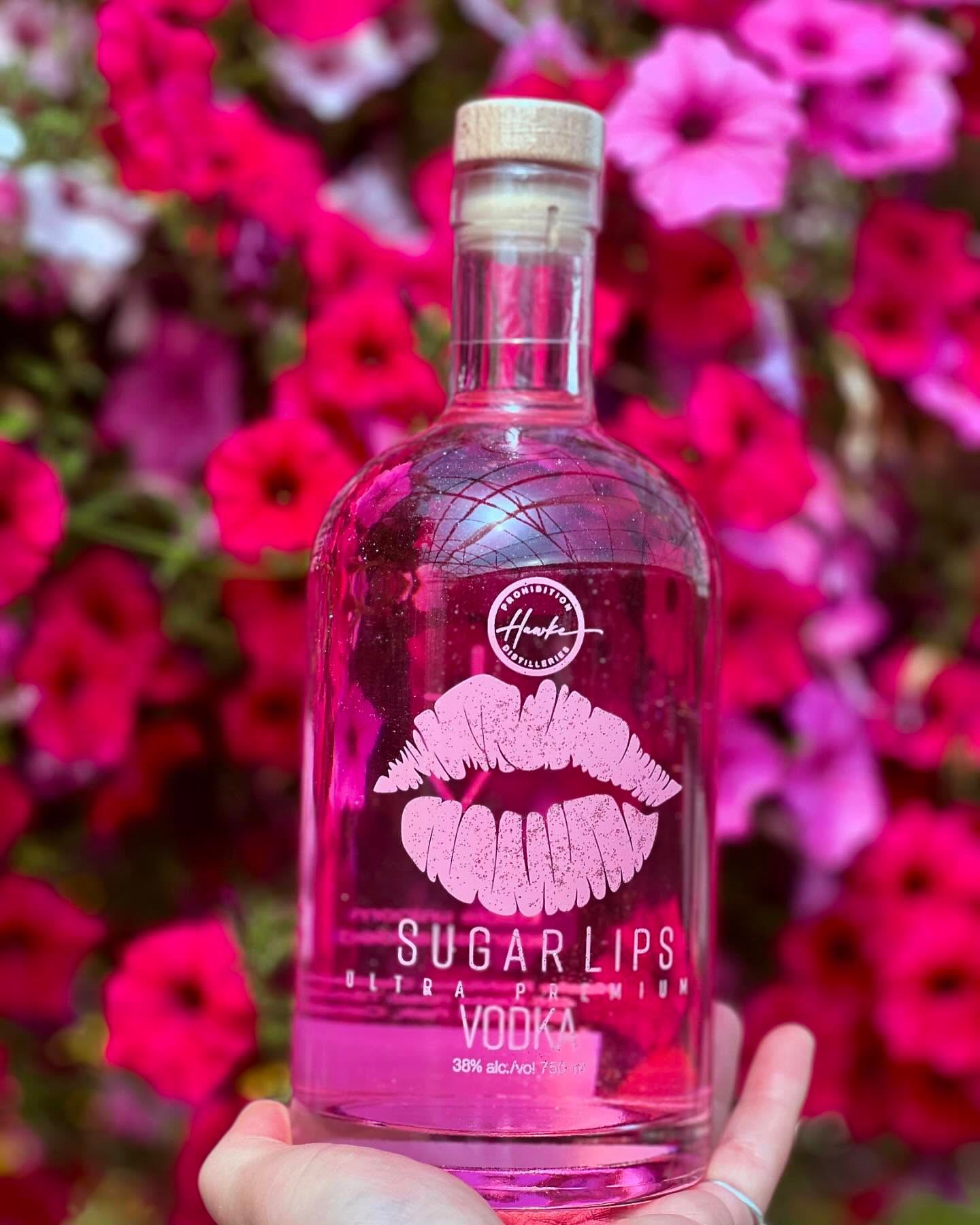 Sugarlips Vodka with flowers in the background.