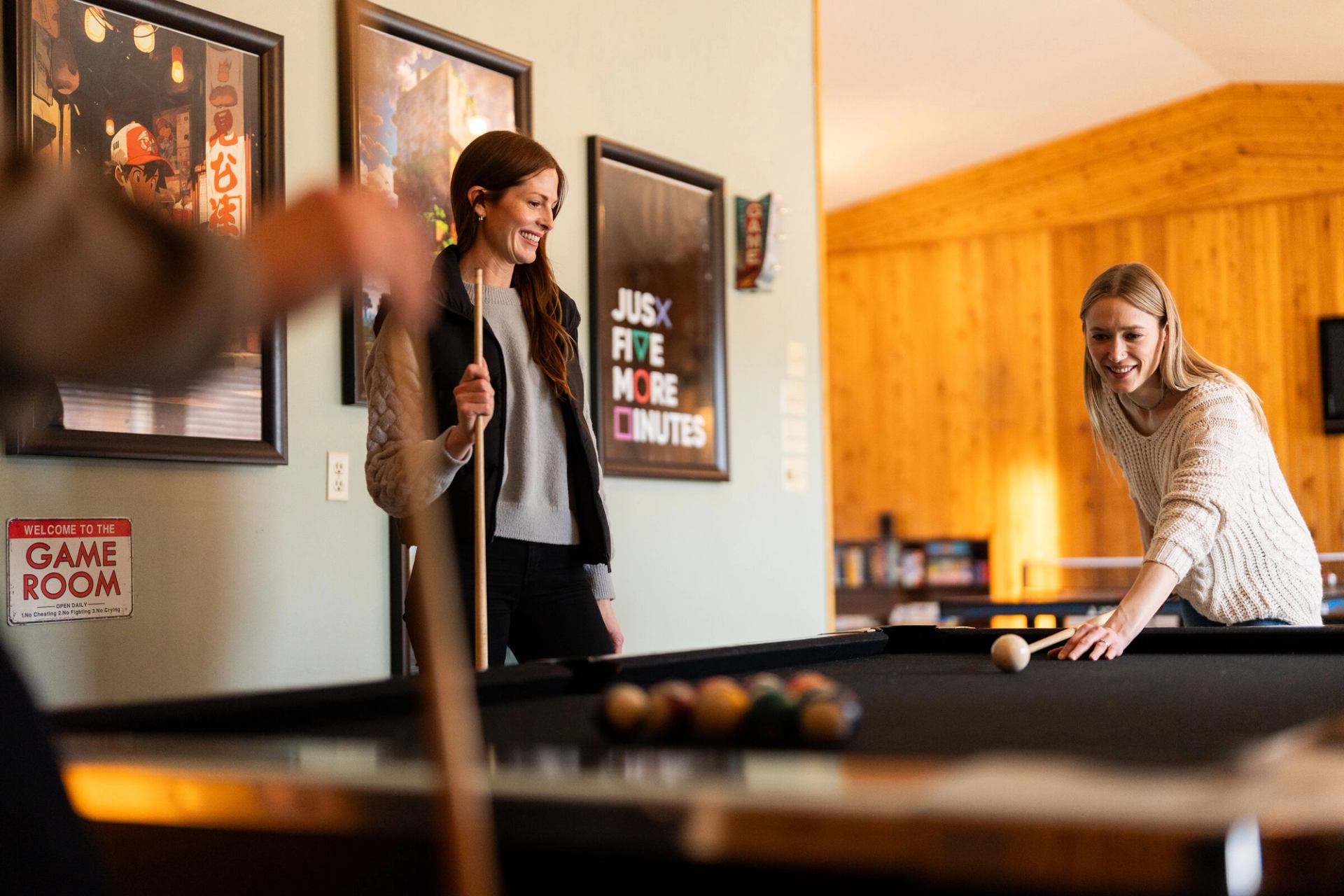 Playing billiards inside a Miette Mountain Cabin.