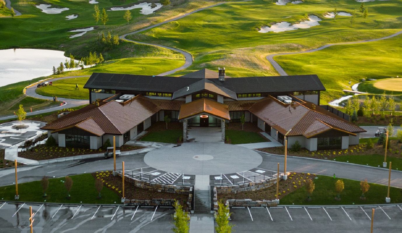 Modern clubhouse at Mickelson National Golf Club surrounded by green fairways.