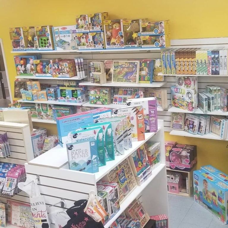Toy book shelves and boxed puzzles in a retail store display area.