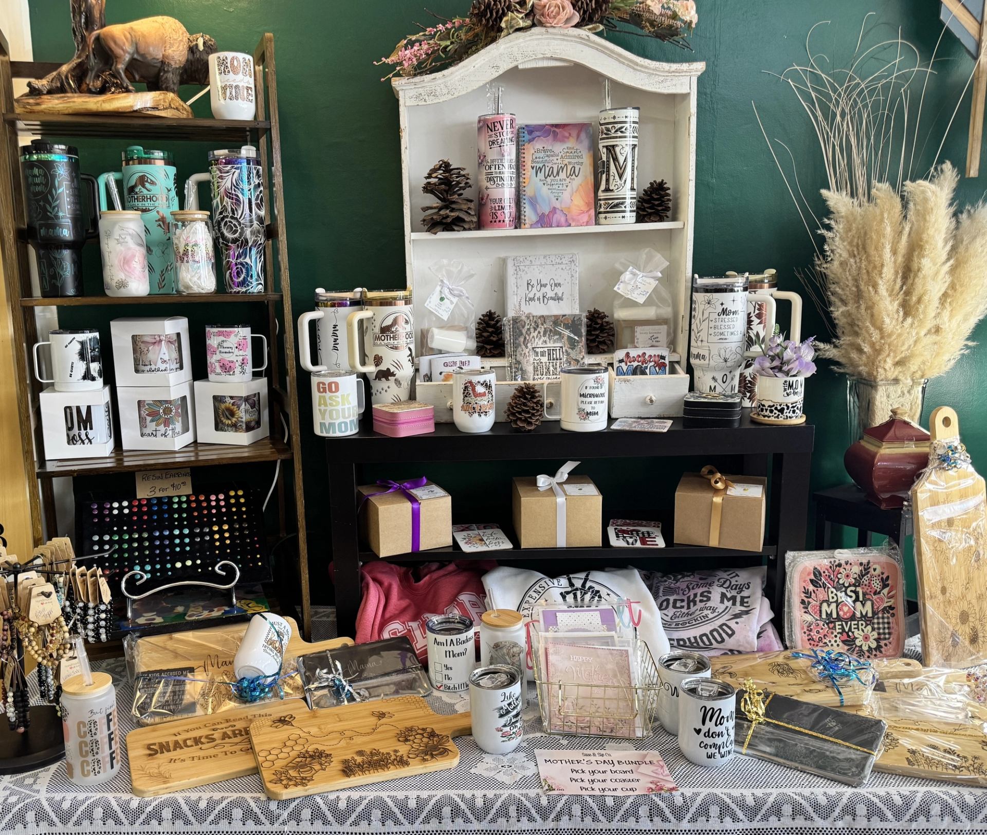 Table and shelves filled with mugs, gift boxes, cutting boards, and handcrafted décor.