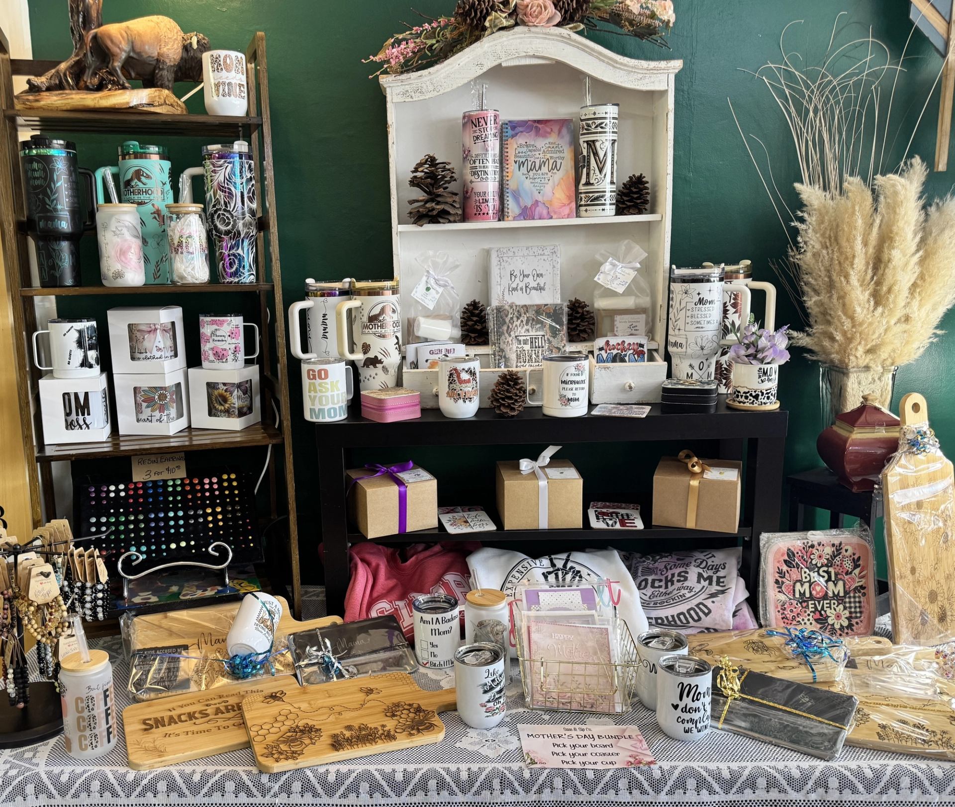 Table and shelves filled with mugs, gift boxes, cutting boards, and handcrafted décor.