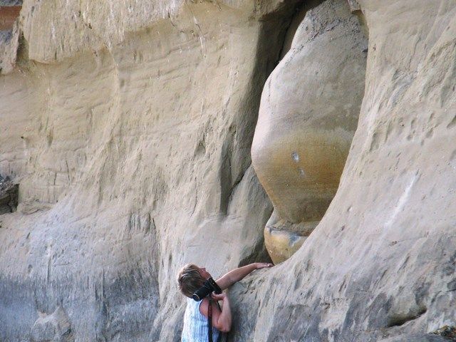 Women taking photos and exploring the Athabasca River Concretions in Alberta.