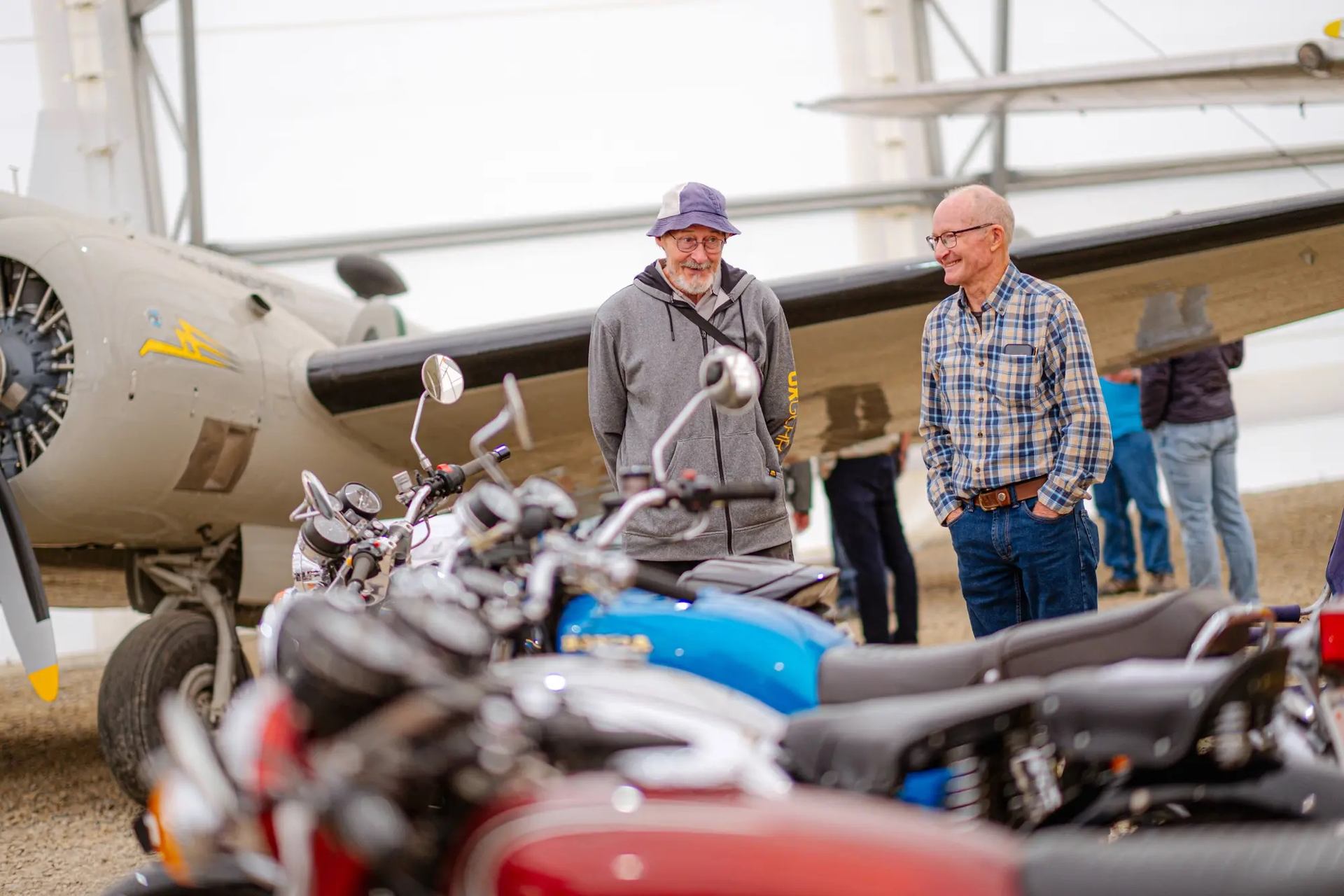 Two men looking at the motorcycle display.