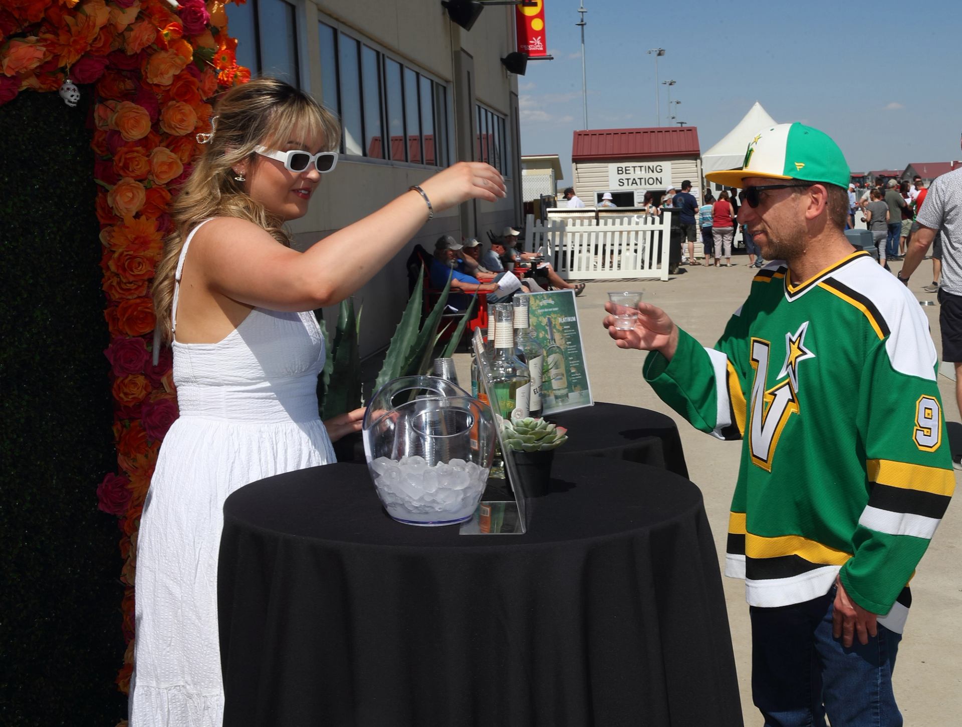 Outdoor drink station with ice bucket and cups at event