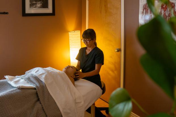 Massage therapist working on head at Jasper Wellness.