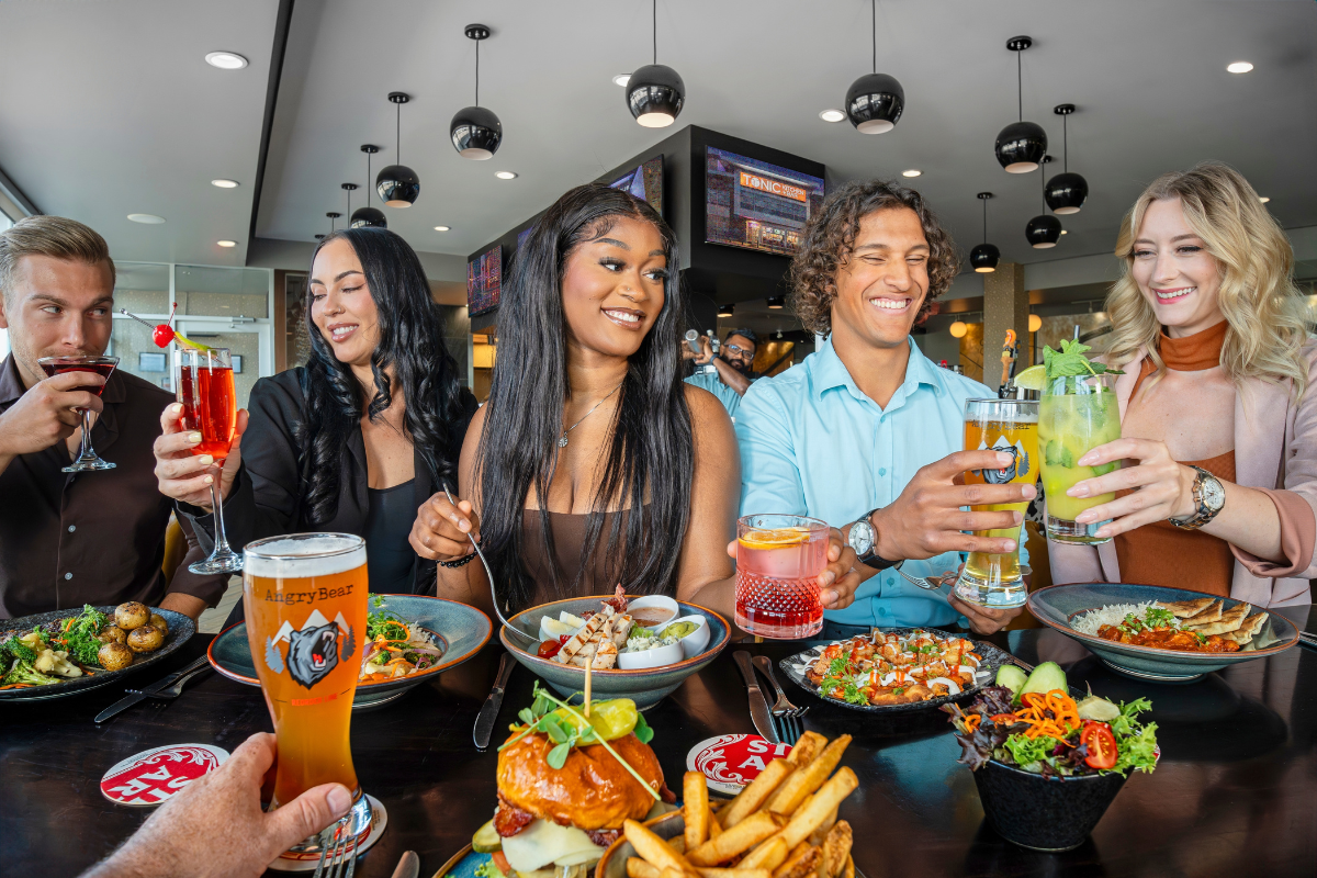 A group of people enjoying food and drinks.