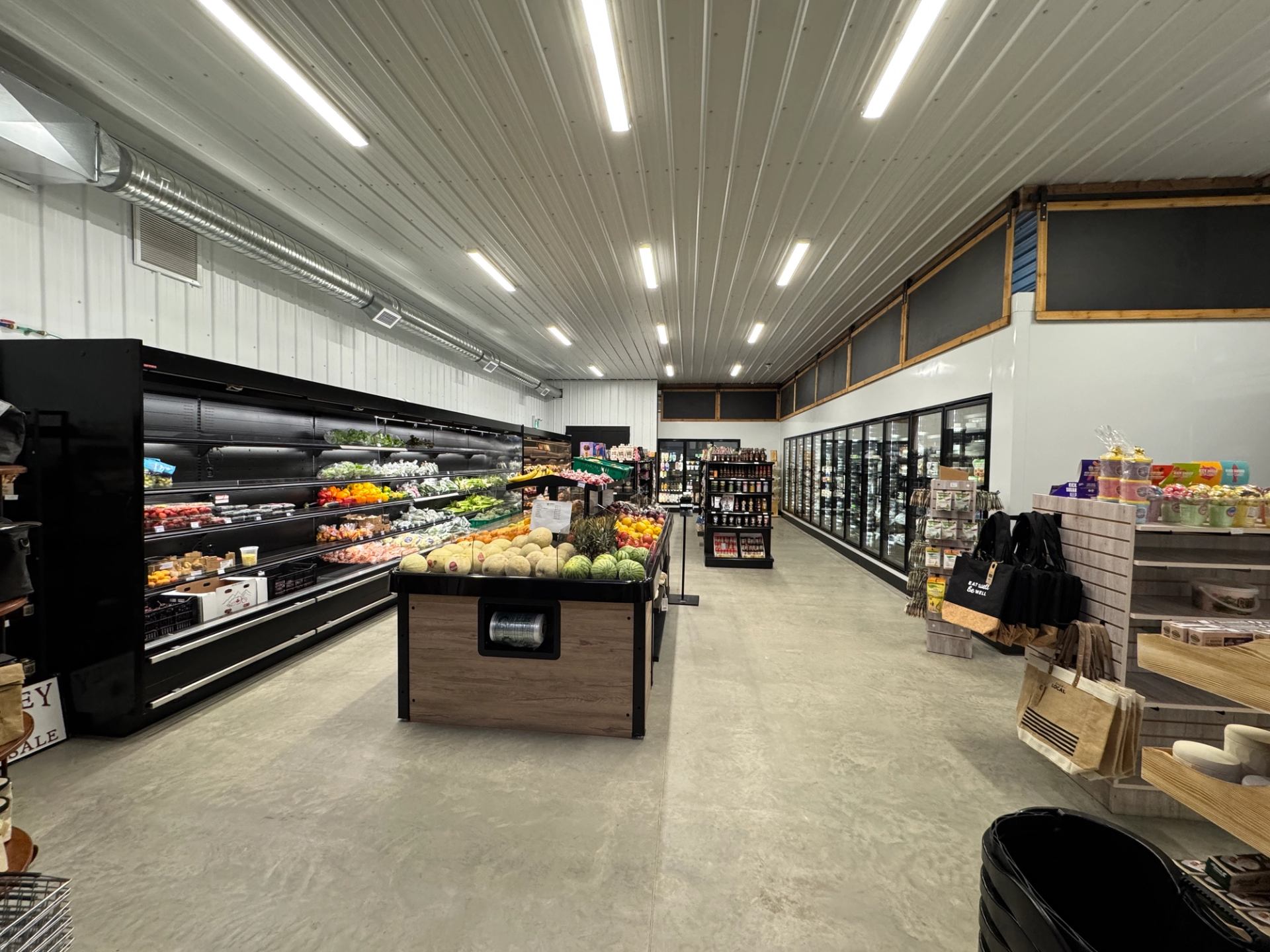 Interior of Farmstead Market & More with shelves of produce and groceries in a clean, well-lit space.
