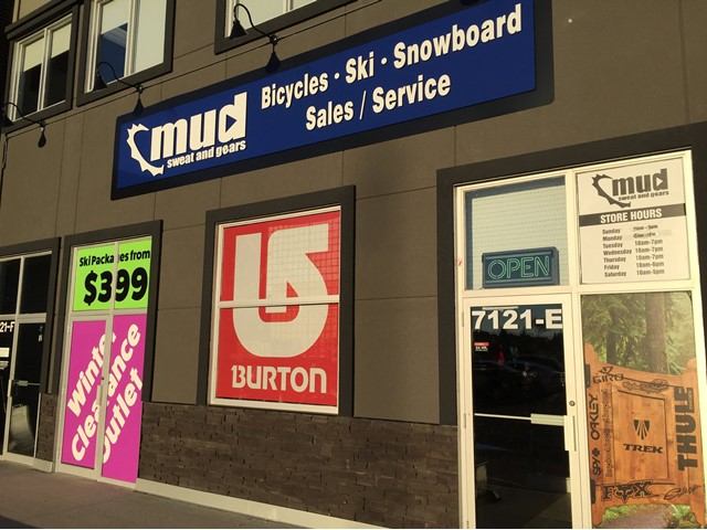 Storefront sign for Mud Sweat and Gears, featuring bicycles, ski and snowboard sales and service.