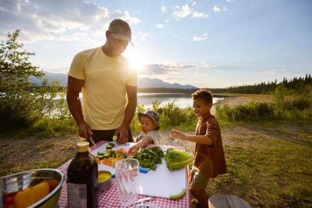 Man and kids having a picnic at Wildhorse Lake Campground in Hinton.