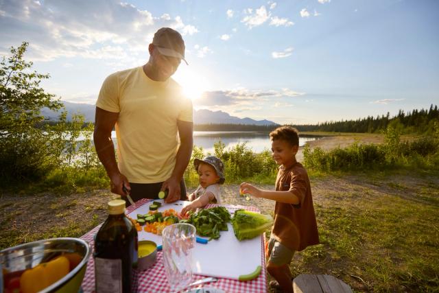 Man and kids having a picnic at Wildhorse Lake Campground in Hinton.