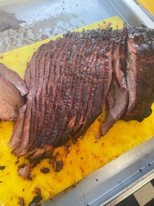 BBQ brisket on a yellow cutting board