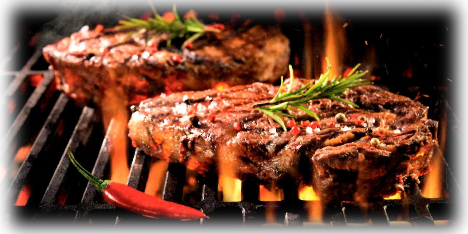 Grilled steaks with rosemary and chili on open flame at JB Grill & Bar.