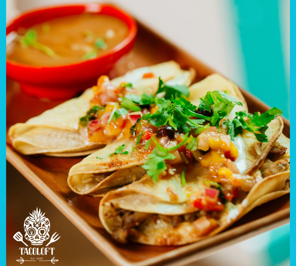 Plate of folded tacos with salsa and coriander beside a bowl of dipping sauce.